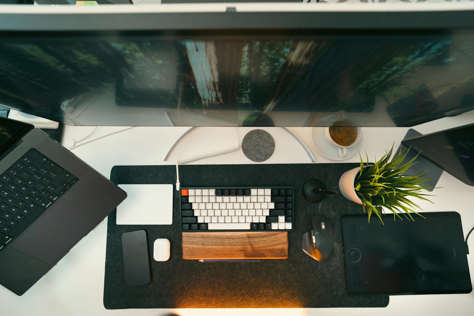 A bird's-eye view of a stylish workspace featuring tech gadgets and modern decor for creative professionals.