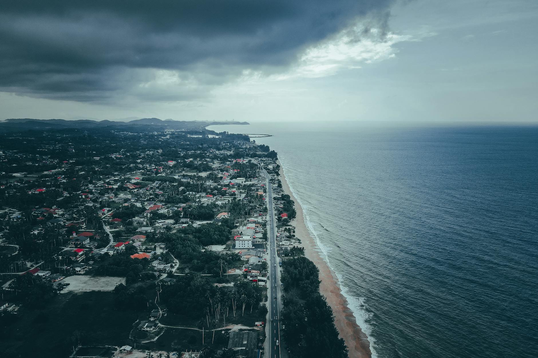 Aerial view of the Marang coastline in Terengganu, Malaysia, showcasing the ocean and coastal cityscape.