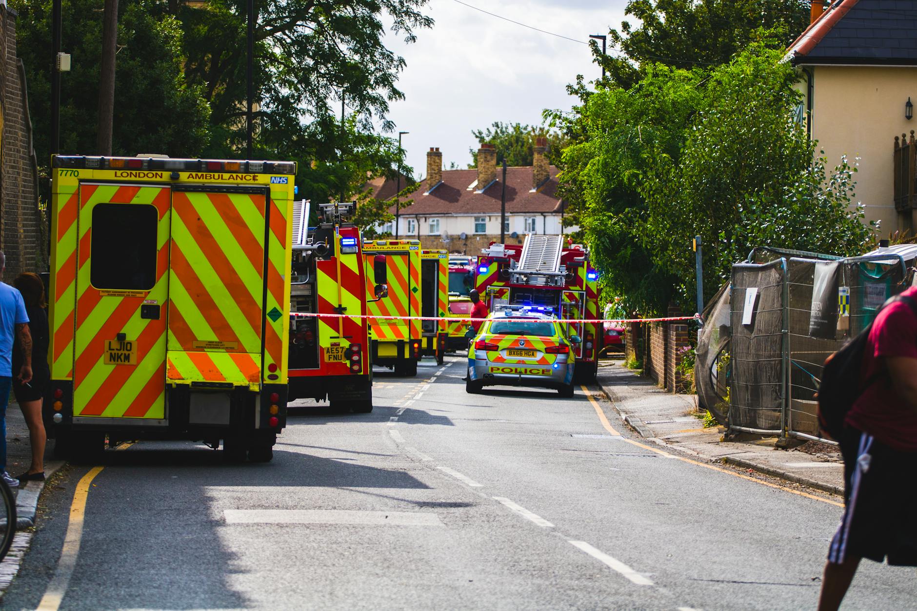Emergency vehicles respond to an incident on a residential street, road closed.